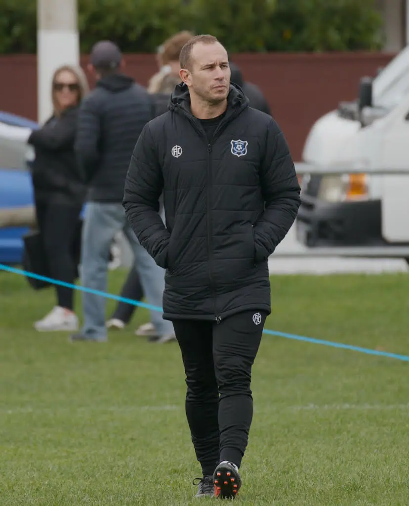 Nathan on the sideline coaching a Wellington football team