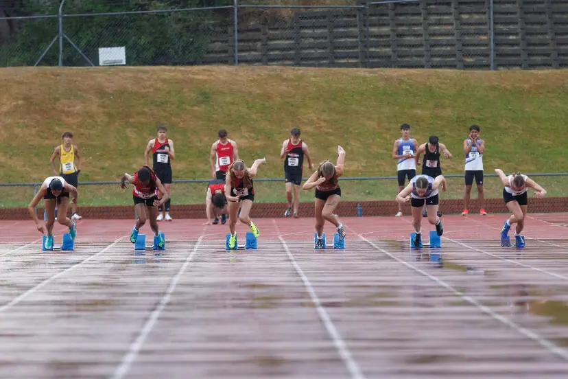 Sprinters driving out of the starting blocks during a race at Newtown Park, Wellington